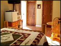 Cozy, clean motel room with coffee maker, condiments, microwave, fridge, and air-conditioning.