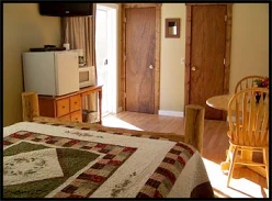 Cozy, clean motel room with coffee maker, condiments, microwave, fridge, and air-conditioning.