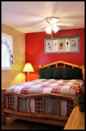 Enjoy a comfy queen bed and ceiling fan breezes in the Red Apple Room.