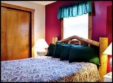“Roost” in comfort on a comfy log-style queen bed in the Red Rooster Suite’s separate bedroom