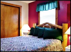 “Roost” in comfort on the log-style queen bed in the Red Rooster Suite