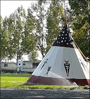 Black robed spirit priest on the Spirit Dancers tepee 