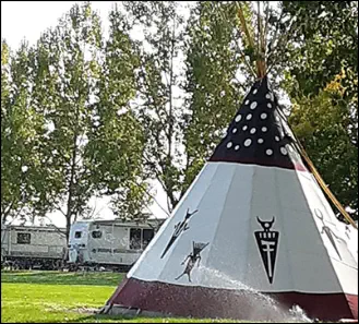 Black robed spirit priest on the Spirit Dancers tepee 